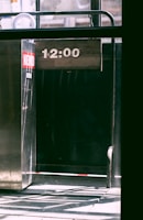 Close-up of a digital clock display showing synchronized time in a busy warehouse.