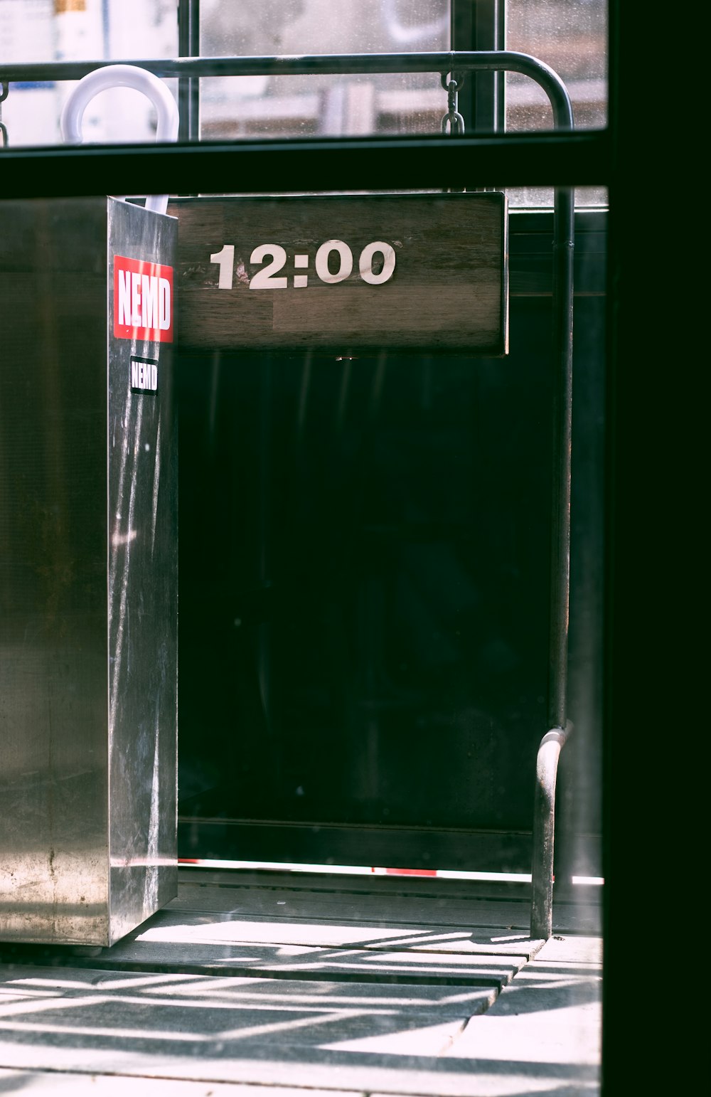 a metal enclosure with a sign that reads 12 00