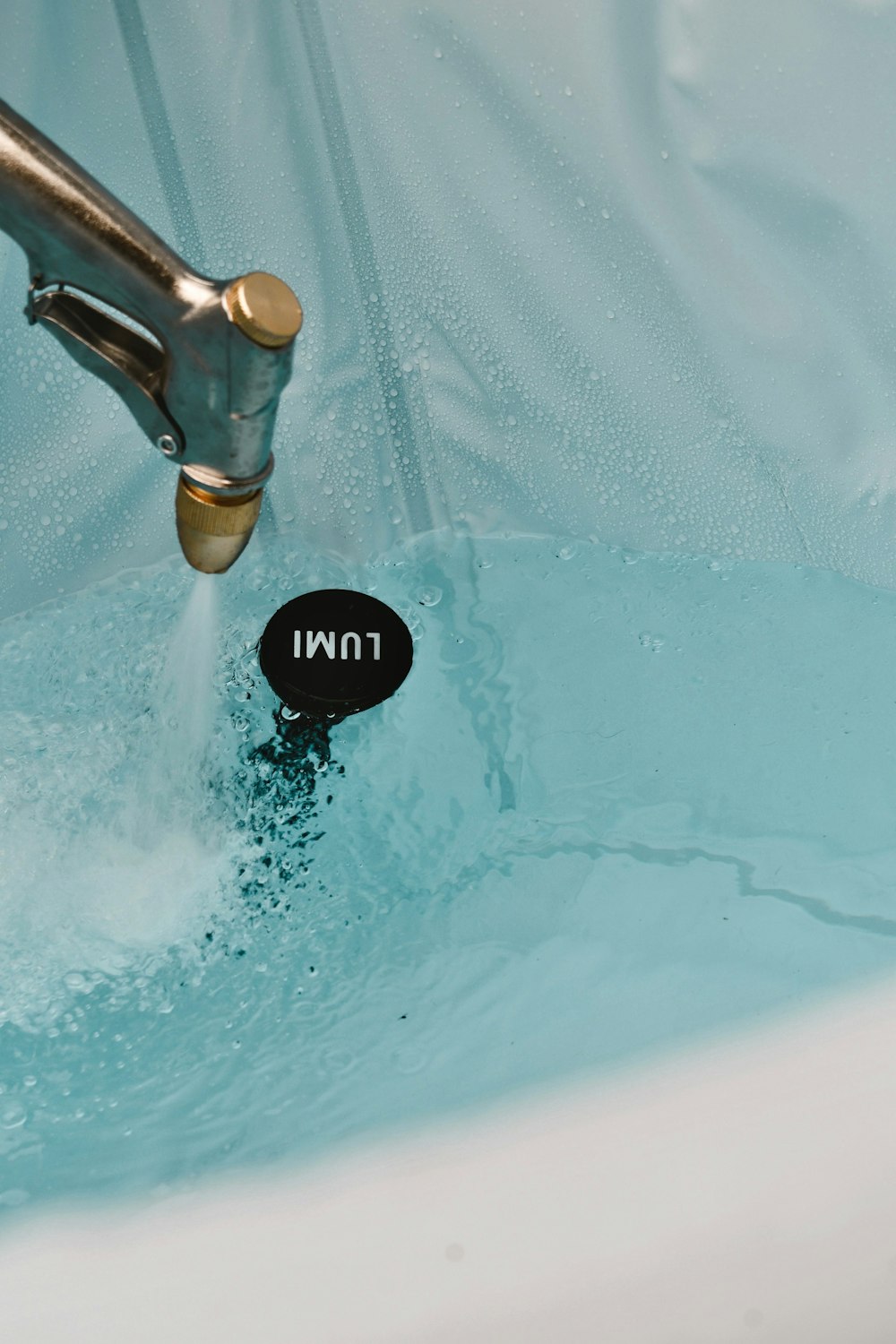 a faucet that is in a bathtub with water