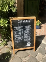 A cozy coffee stand with a chalkboard sign inviting customers to connect.