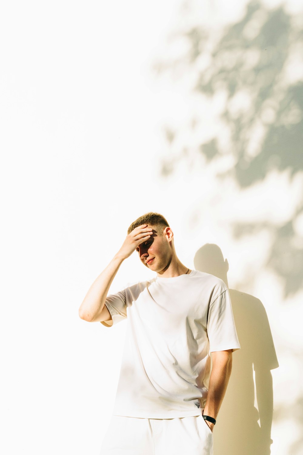 a man standing in front of a white wall