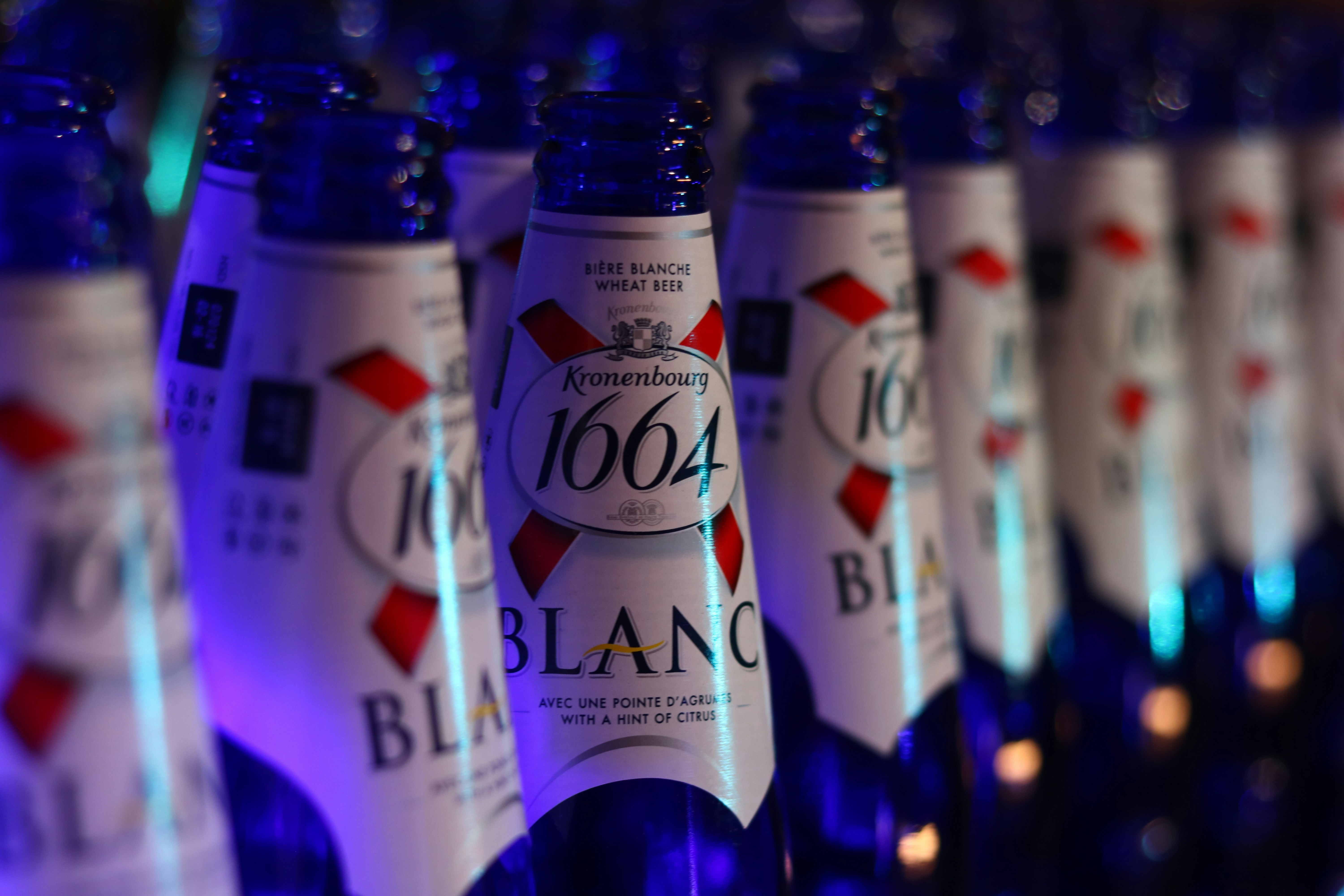 a row of bottles of alcohol sitting on a shelf