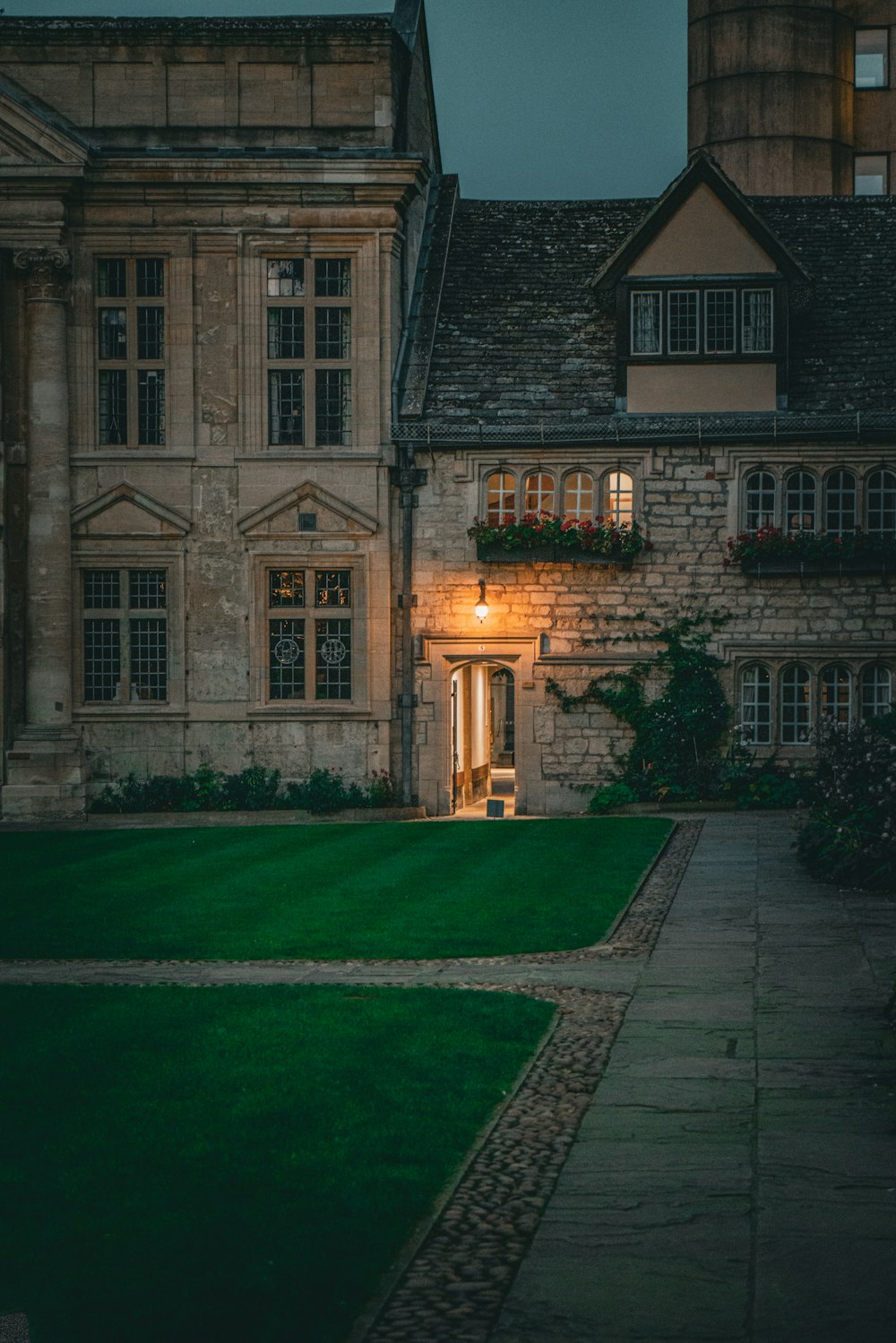 a large house with a green lawn in front of it