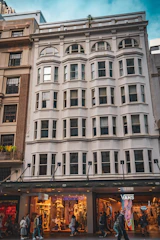A renovated commercial property with storefronts and people walking by.