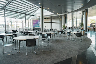 Cozy medium-sized event room with comfortable lighting, carpeted floors, and air conditioning creating an elegant atmosphere.