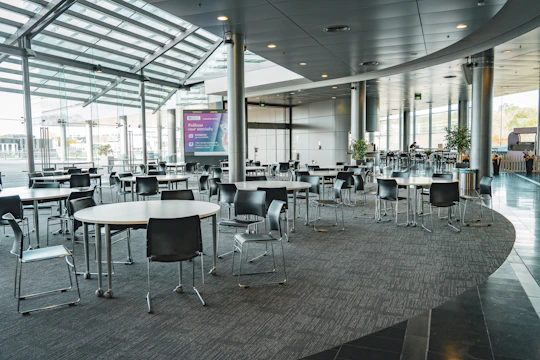 Cozy medium-sized event room with comfortable lighting, carpeted floors, and air conditioning creating an elegant atmosphere.
