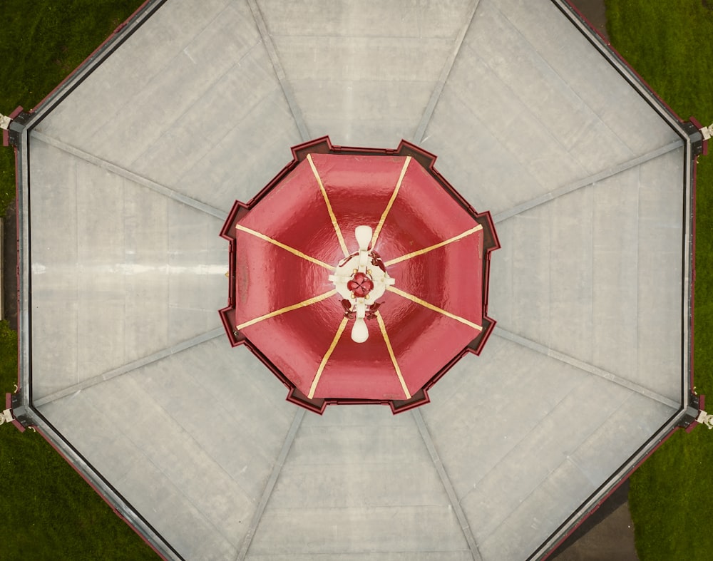 an overhead view of a red and white umbrella