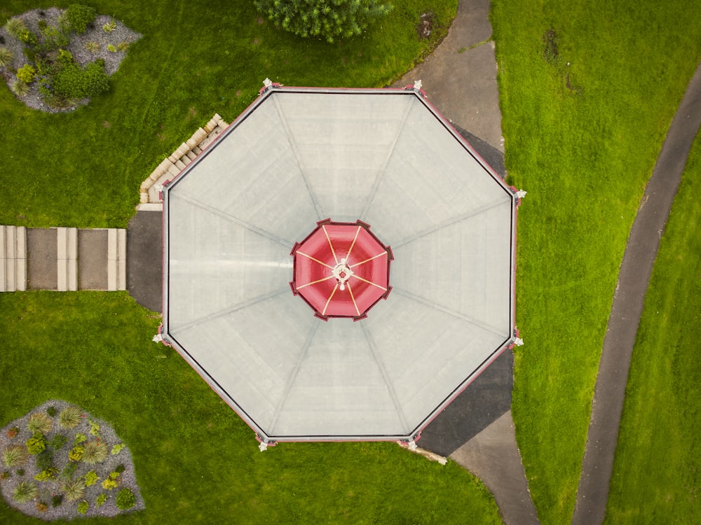 an overhead view of a red and white umbrella