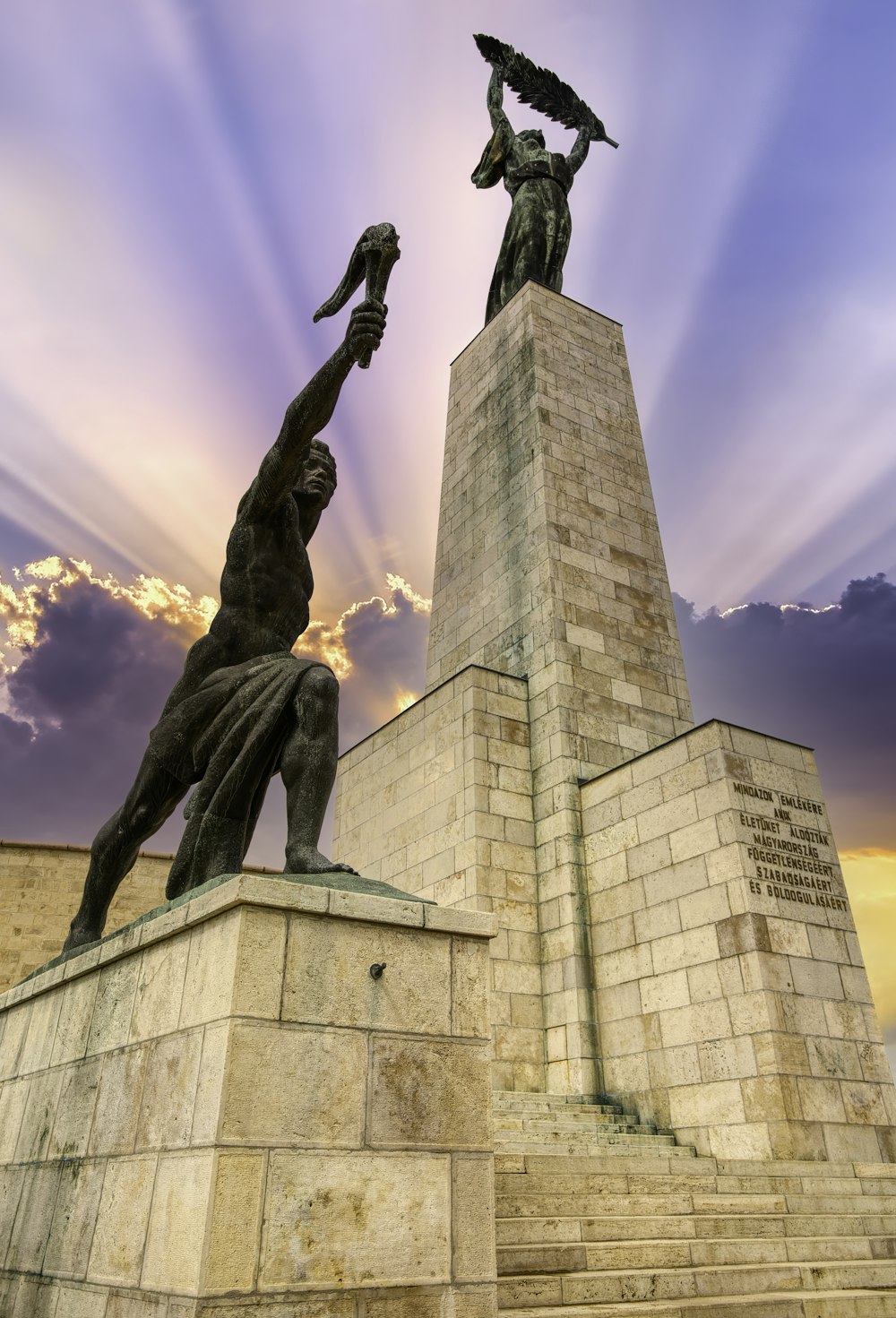 a statue of a man holding a bird in his hand