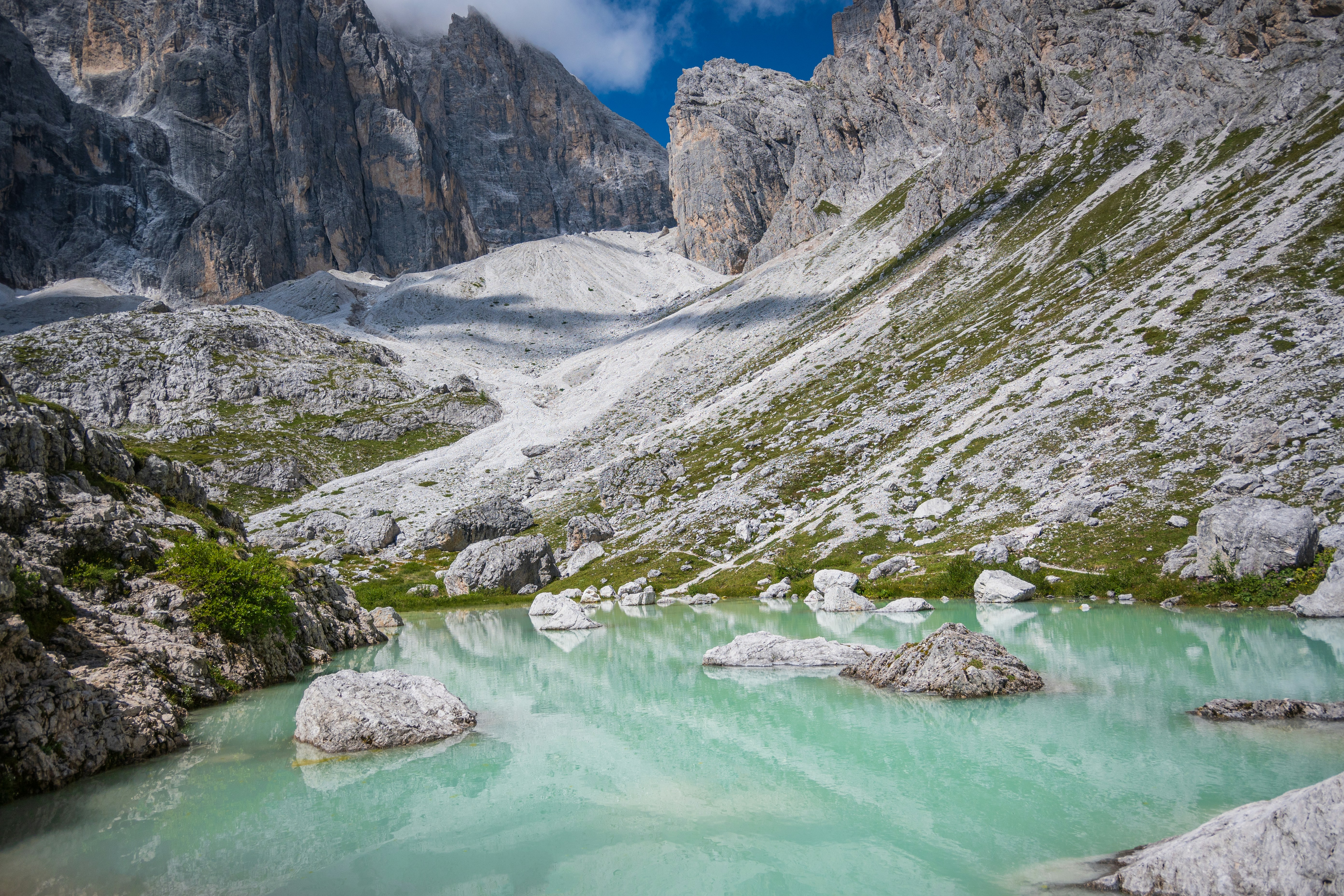 a mountain lake surrounded by rocks and green water