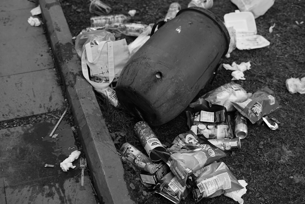 a black and white photo of trash and a suitcase
