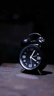 The 11:11 clock glowing brightly on a nightstand beside the 'King of the Jews' poster.