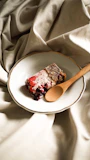 Delicious homemade dessert with berries and cream on a rustic plate