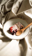 Delicious homemade dessert with berries and cream on a rustic plate