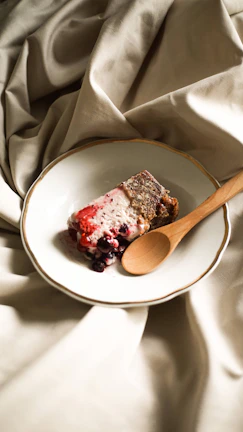 A beautifully plated dessert with fresh berries and a drizzle of sauce.