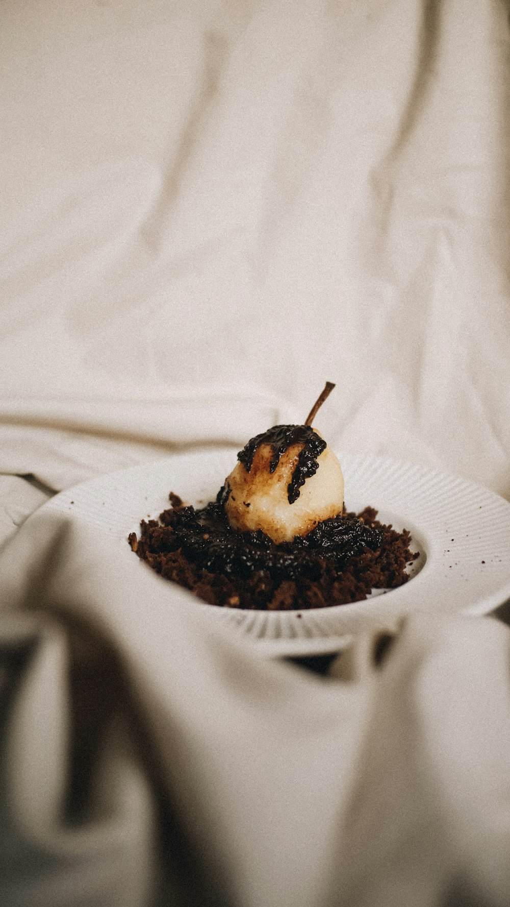 a white plate topped with food on top of a bed