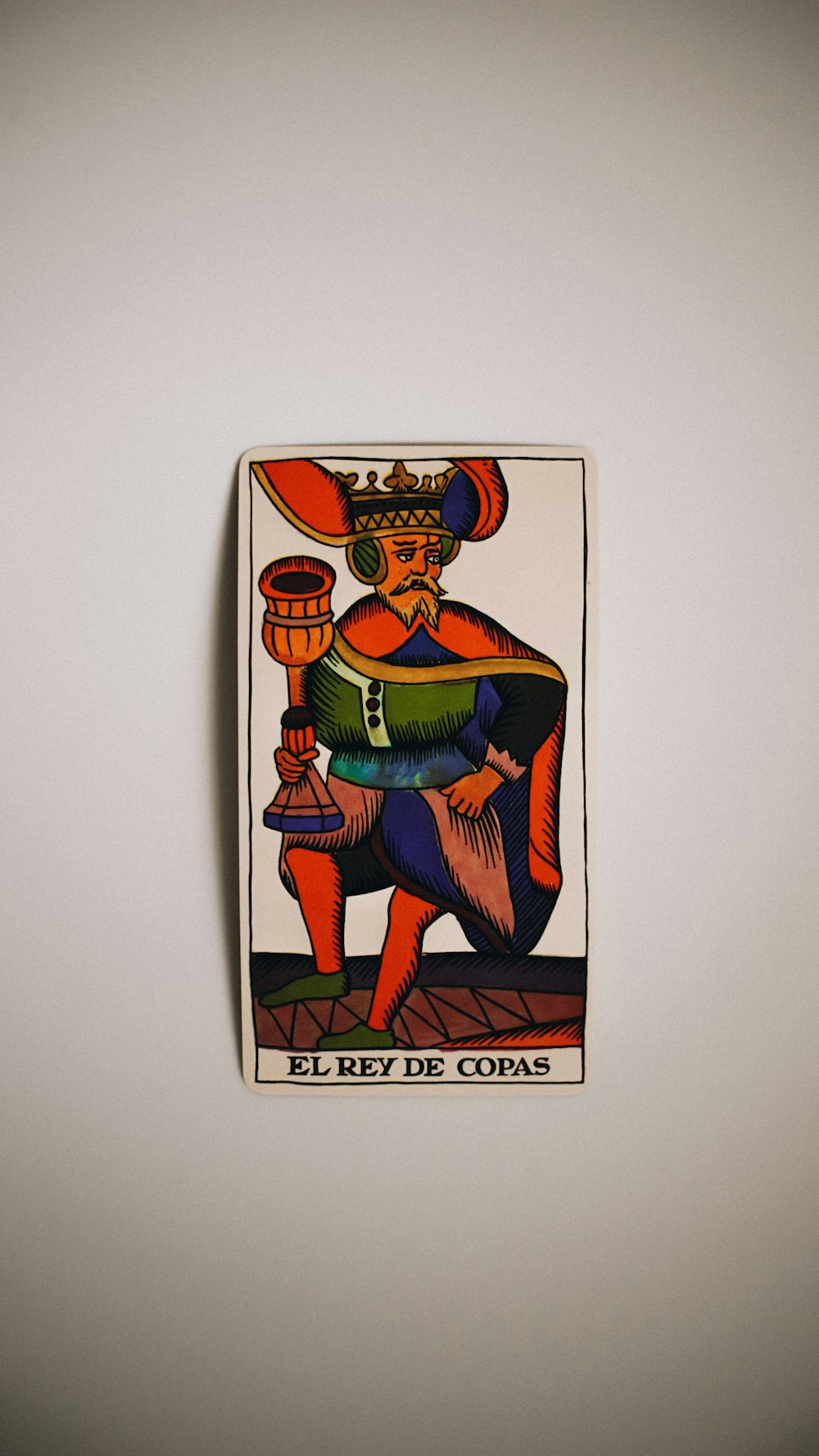 a picture of a king of cups on a wall