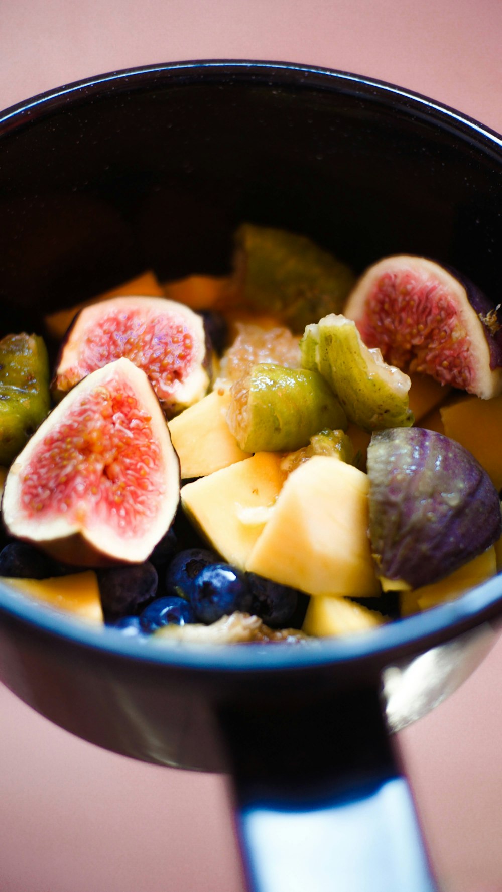 a close up of a bowl of fruit on a table