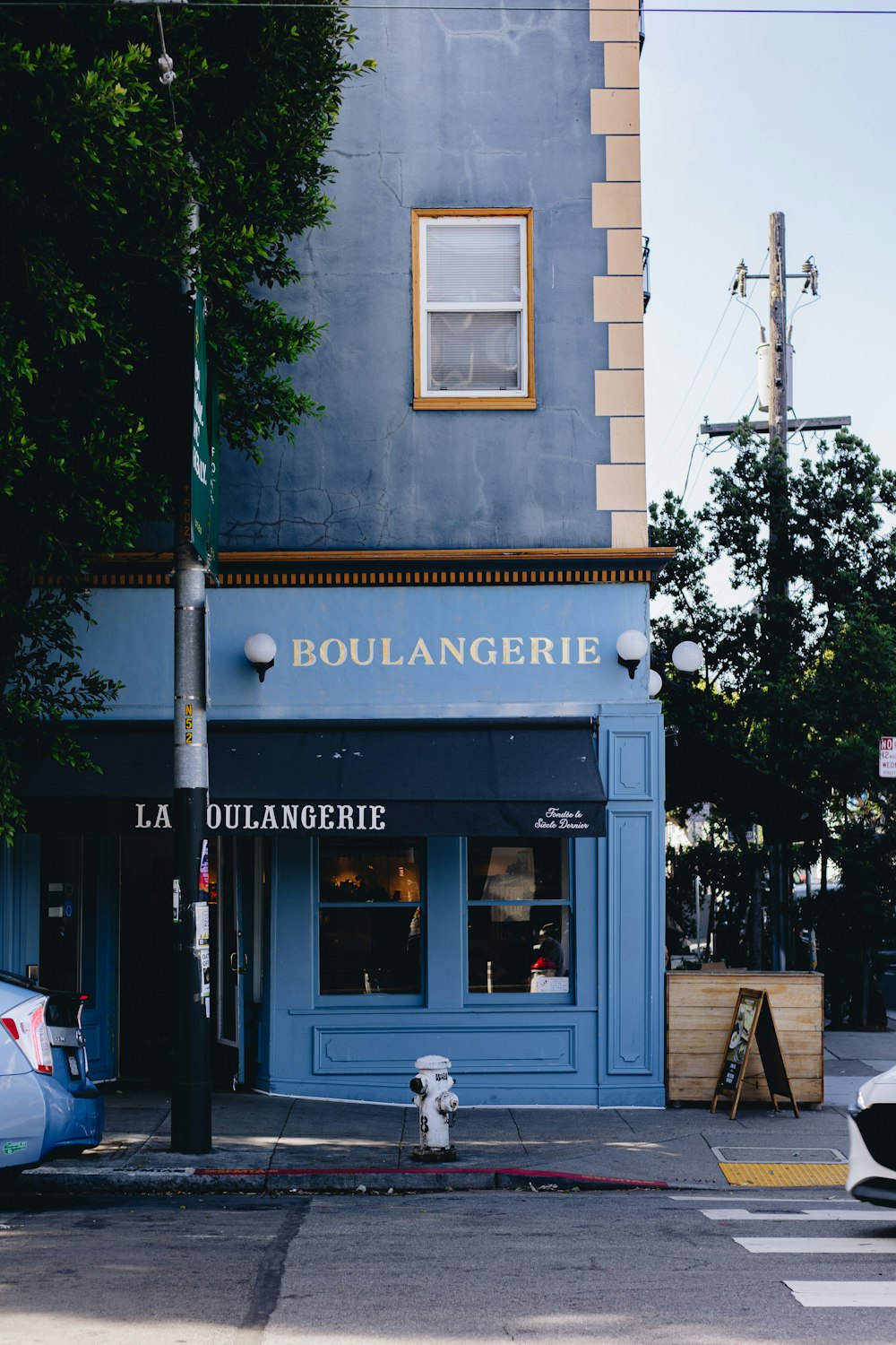 a street corner with a blue building and a fire hydrant