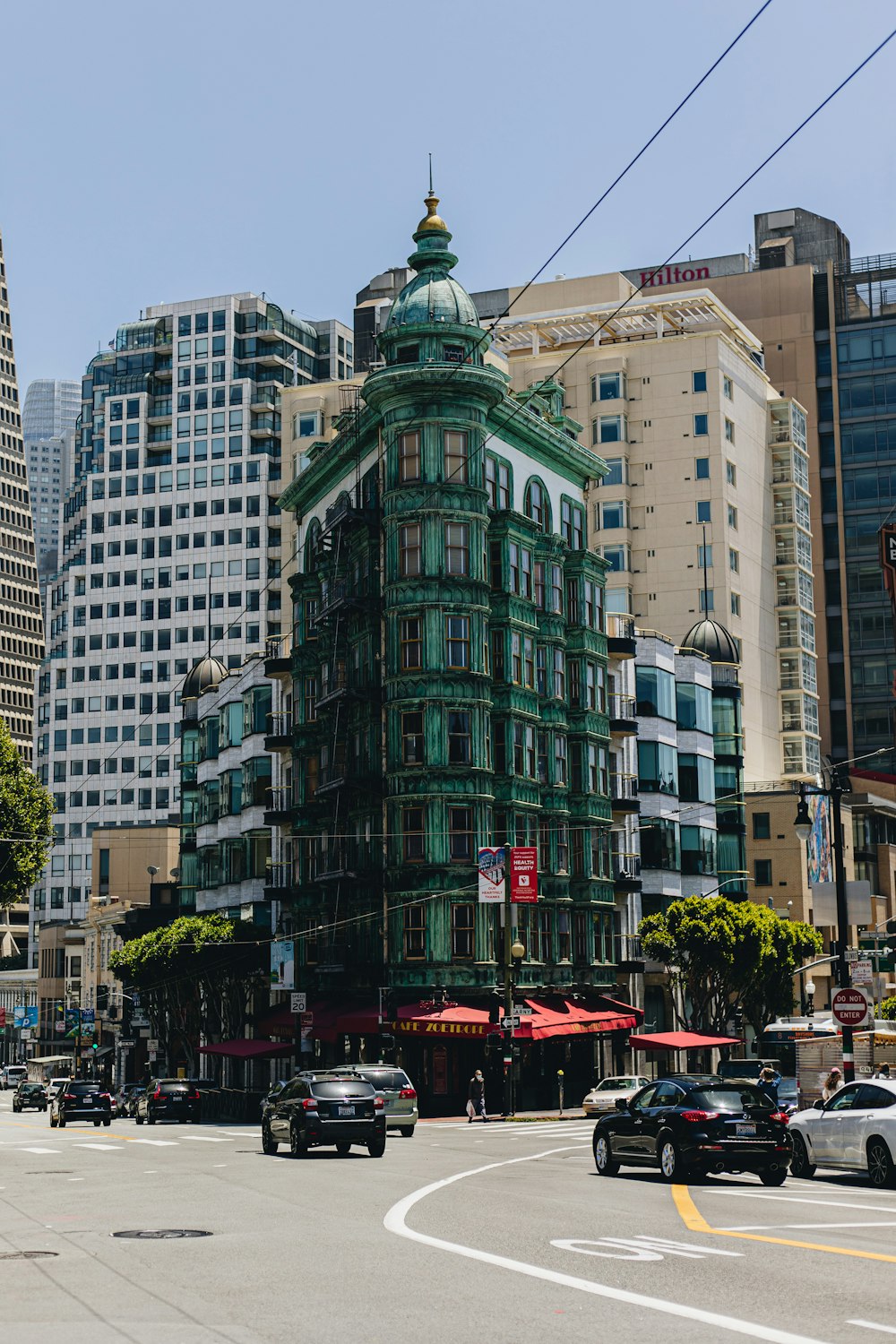 a large green building in the middle of a city