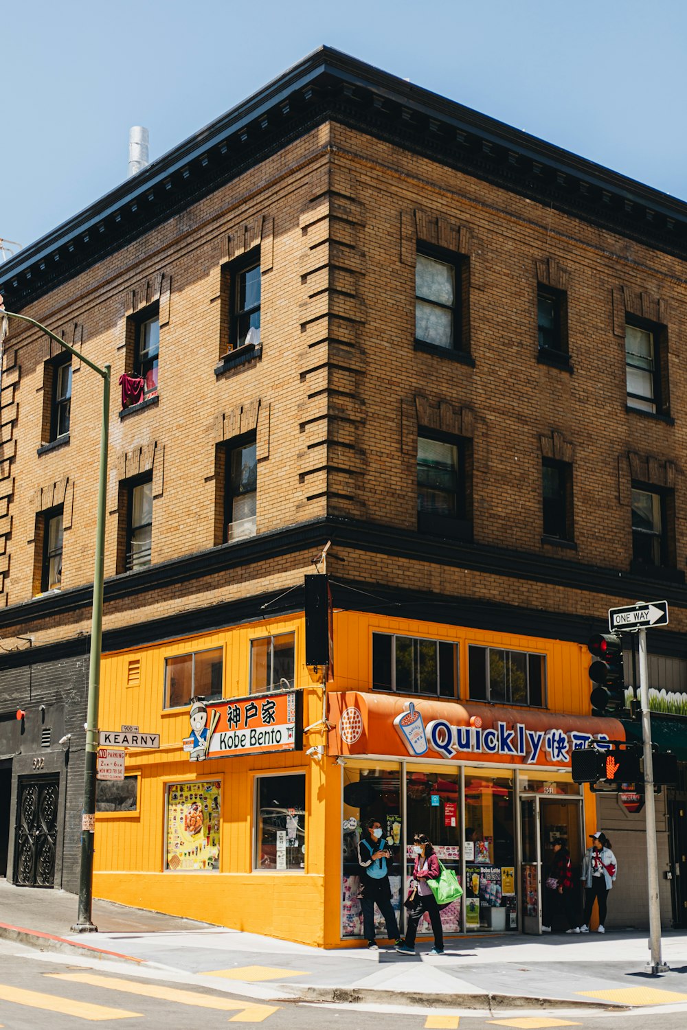 a yellow building on a city street corner