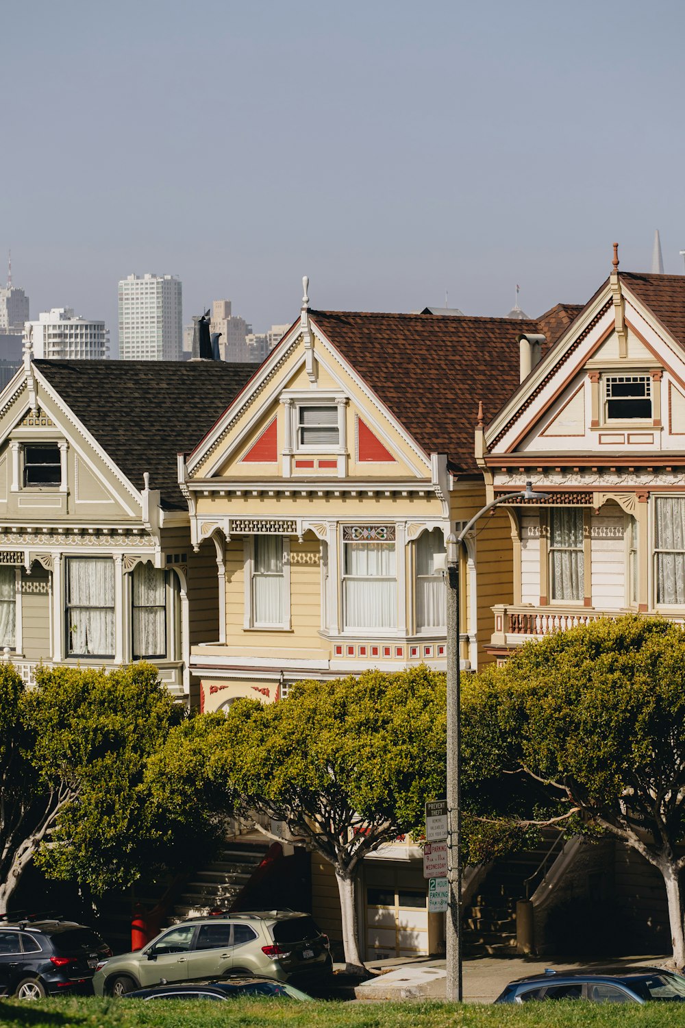 a row of houses with cars parked in front of them