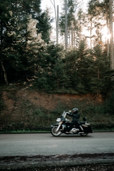 A rider enjoying a scenic countryside road on a classic motorcycle.