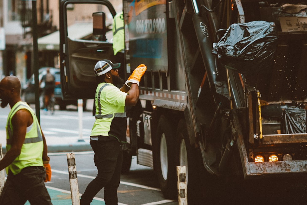 a man in a yellow vest is holding a piece of paper