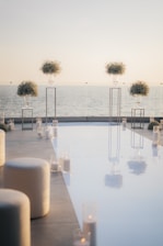 An elegant corporate event setup with black and gold accents overlooking a coastal view.