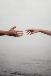 two hands reaching out towards each other