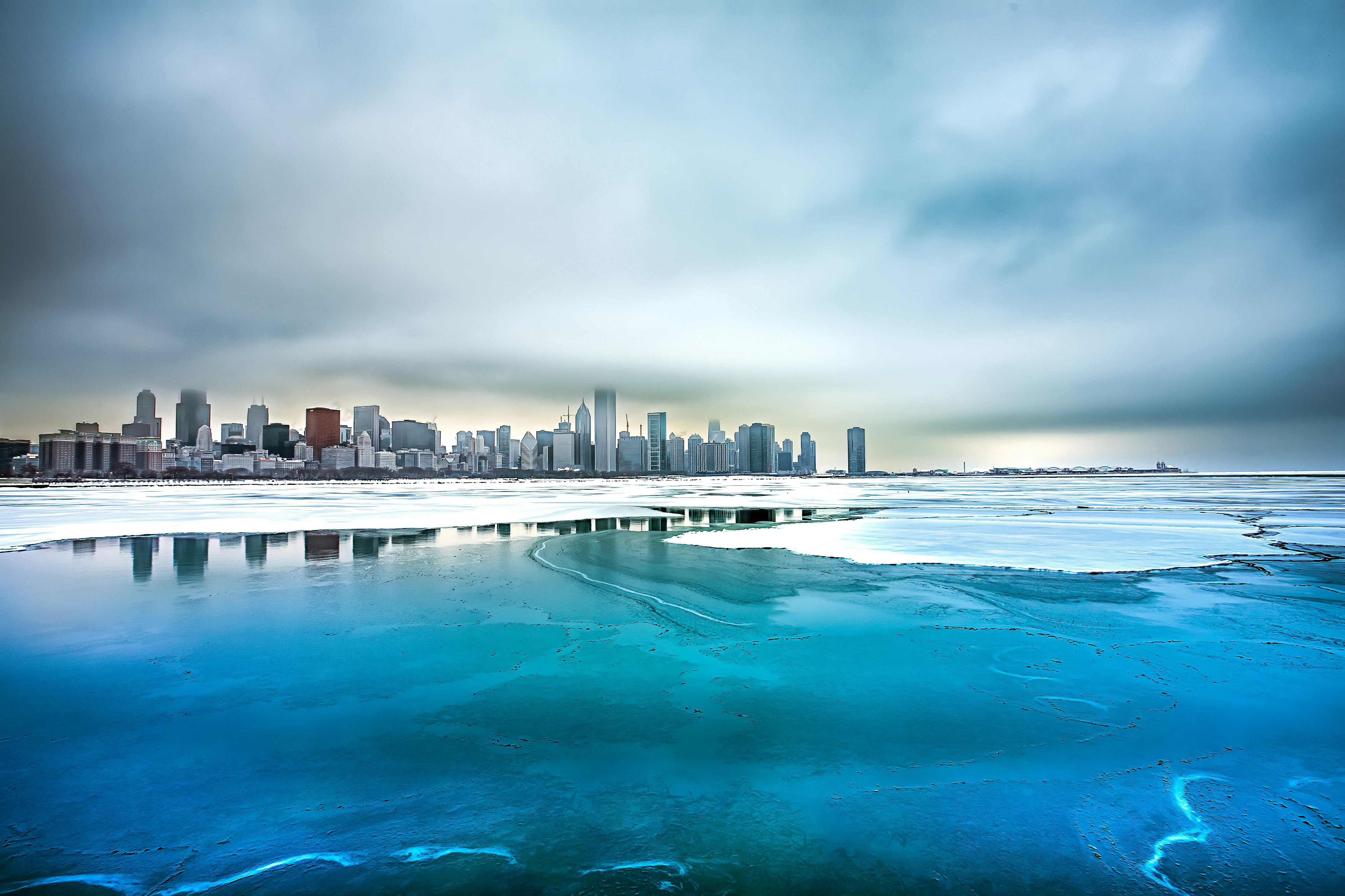 a large body of water with a city in the background