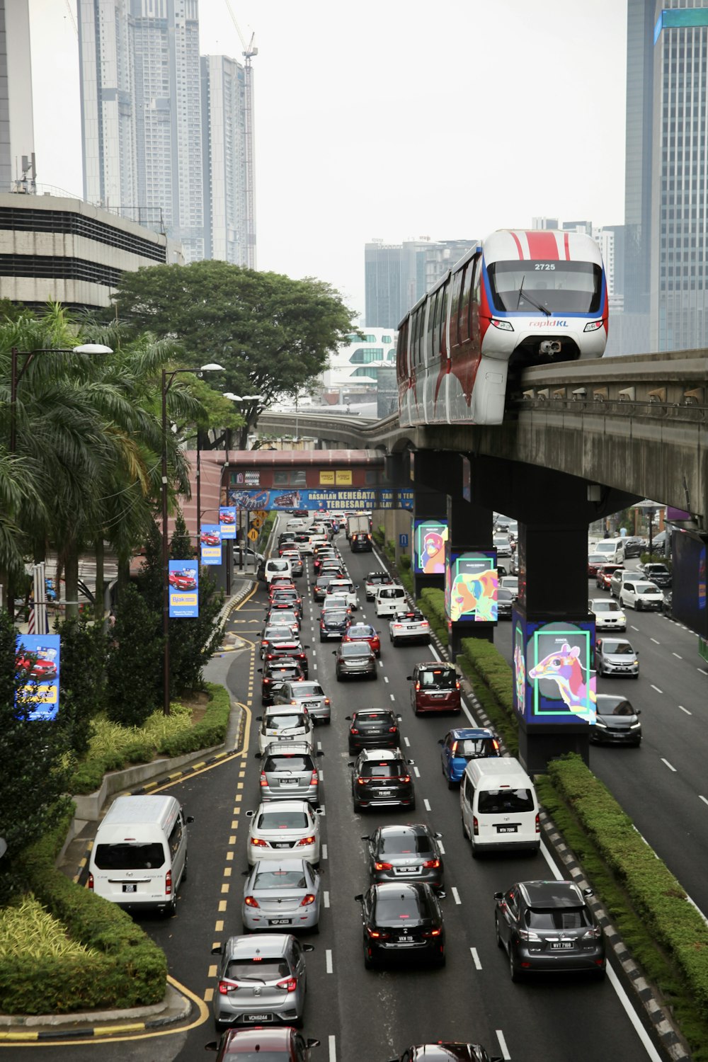 a street filled with lots of traffic next to tall buildings