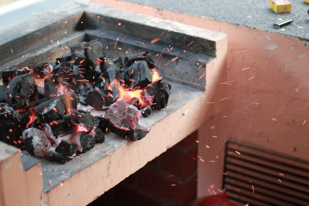 eine Feuerstelle mit einem Haufen Kohlen darauf