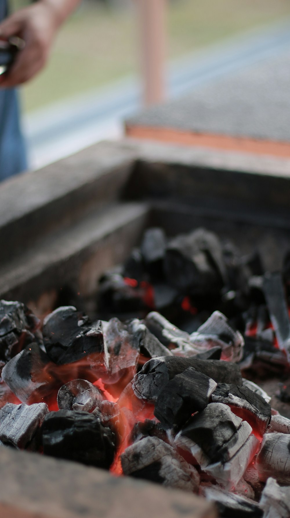 a person is using a cell phone near a fire pit