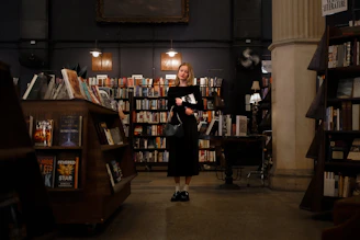 Author reading an excerpt at a cozy bookstore event.