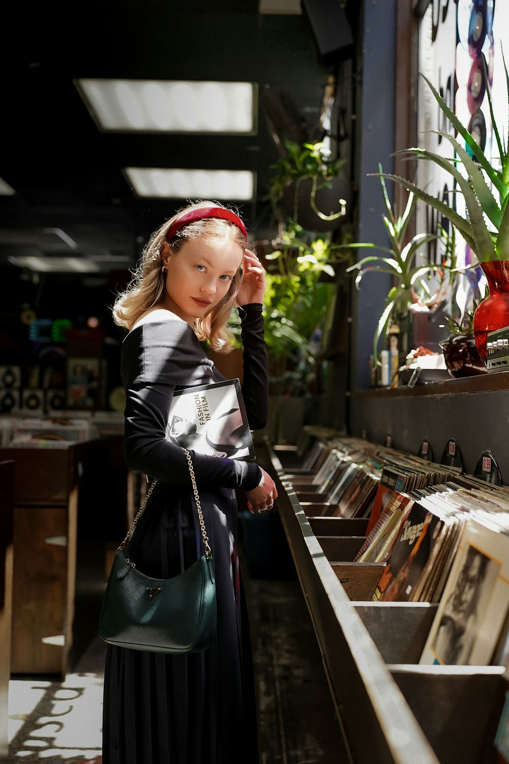 a little girl that is standing in front of a shelf