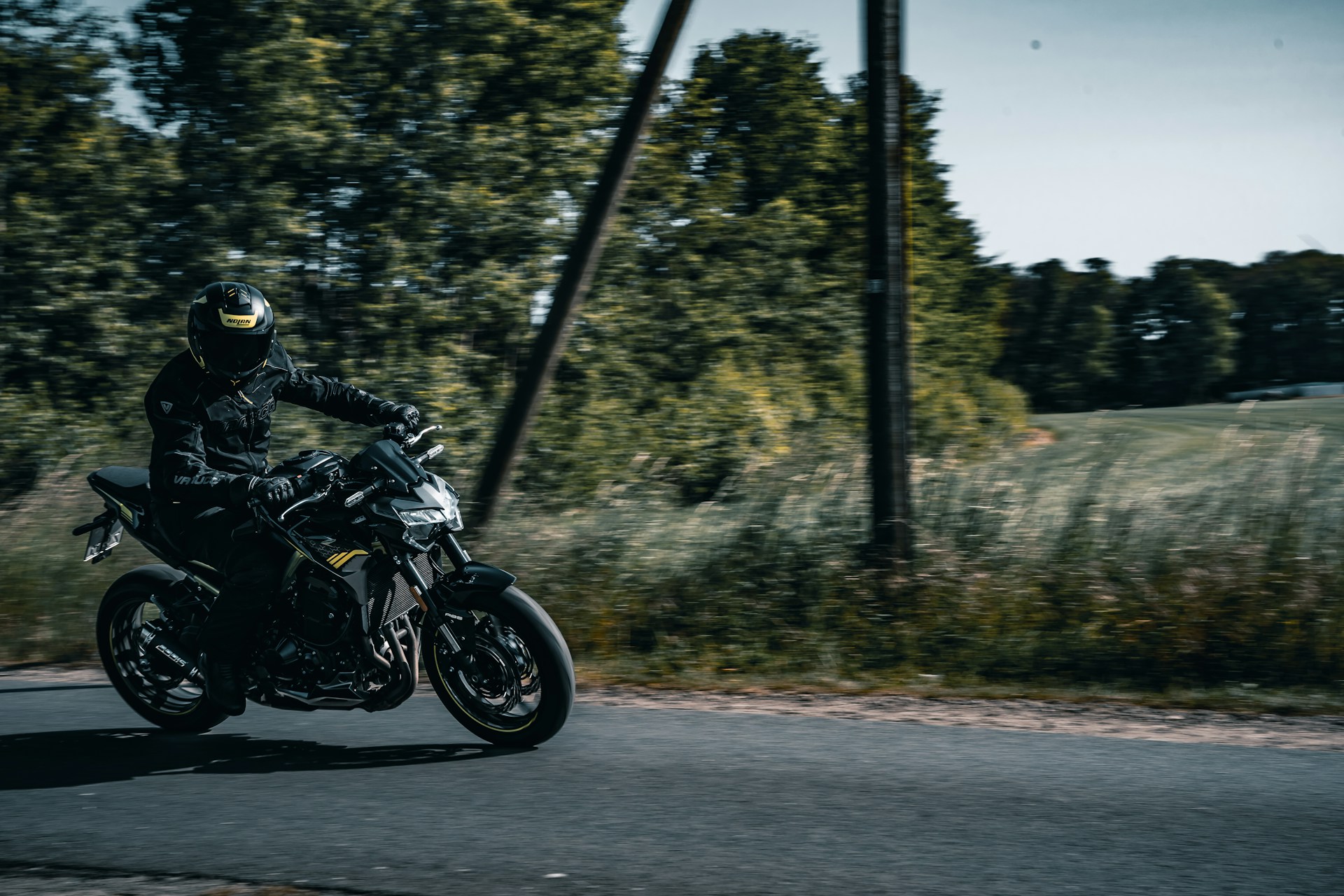 An action shot of a motorcyclist navigating through a winding road, embodying the thrill of adventure and freedom.