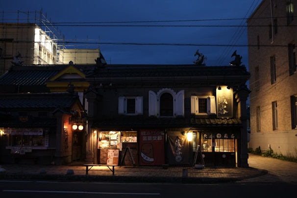 Facade of a restored historic Casabravo house blending traditional architecture with warm lighting at sunset.