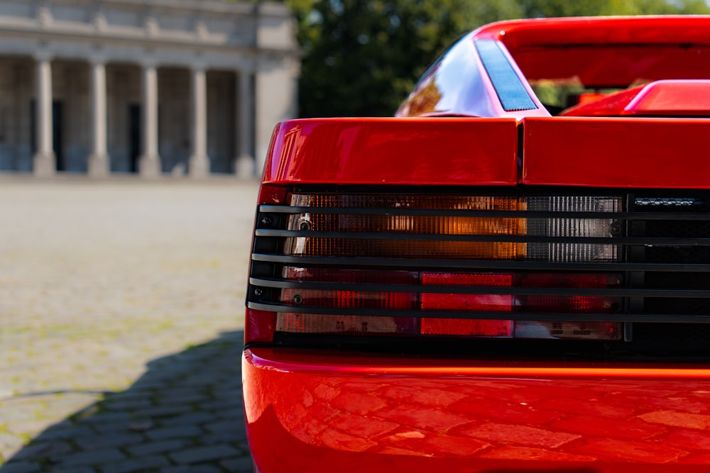 a red sports car parked in front of a building