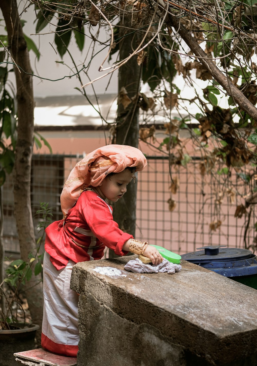 a little girl that is standing on a ledge