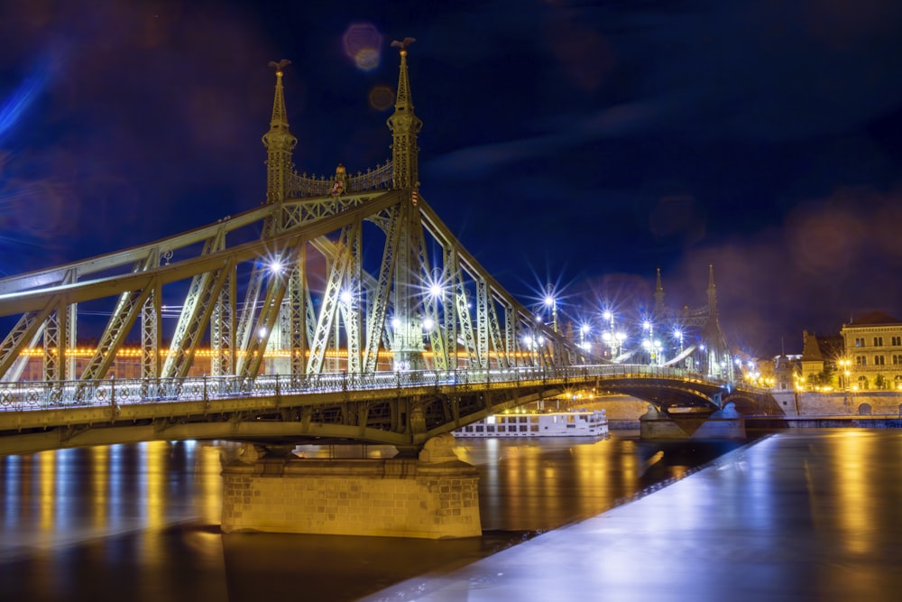 a bridge over a body of water at night