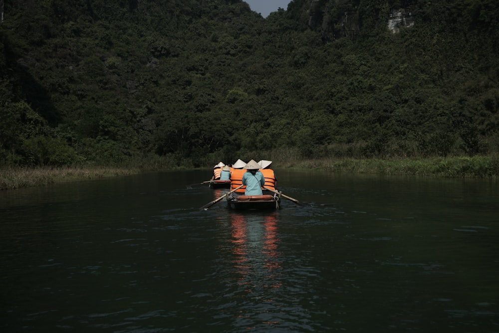 a couple of people on a small boat in the water