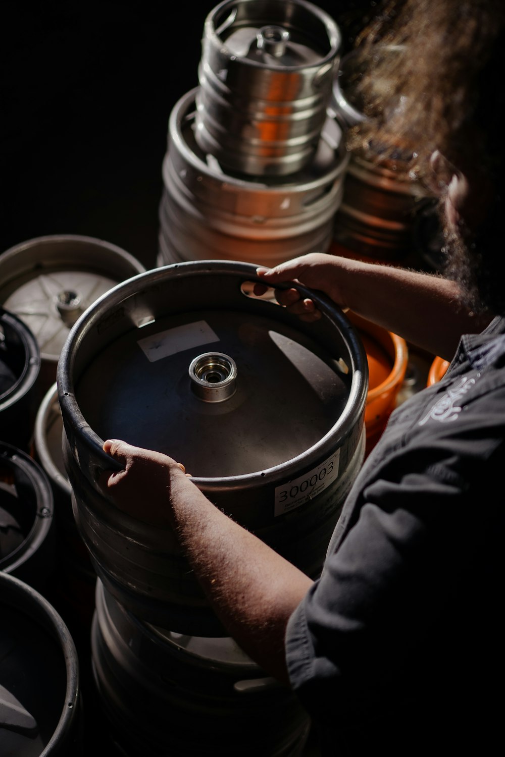 a man is working on a large barrel