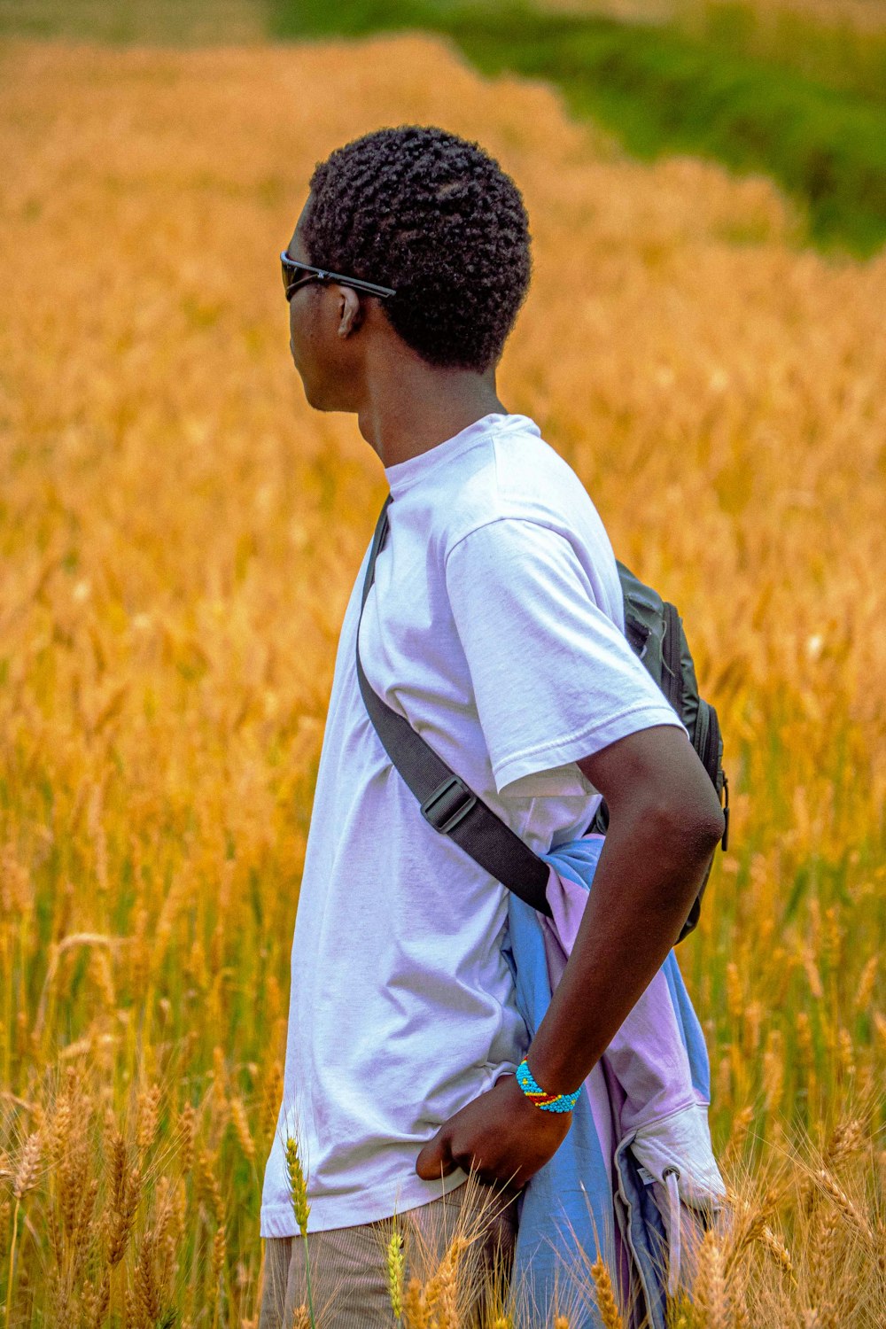 a man standing in a field of tall grass