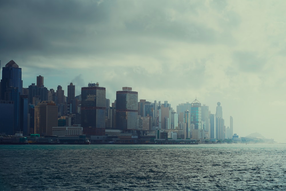 a large body of water with a city in the background