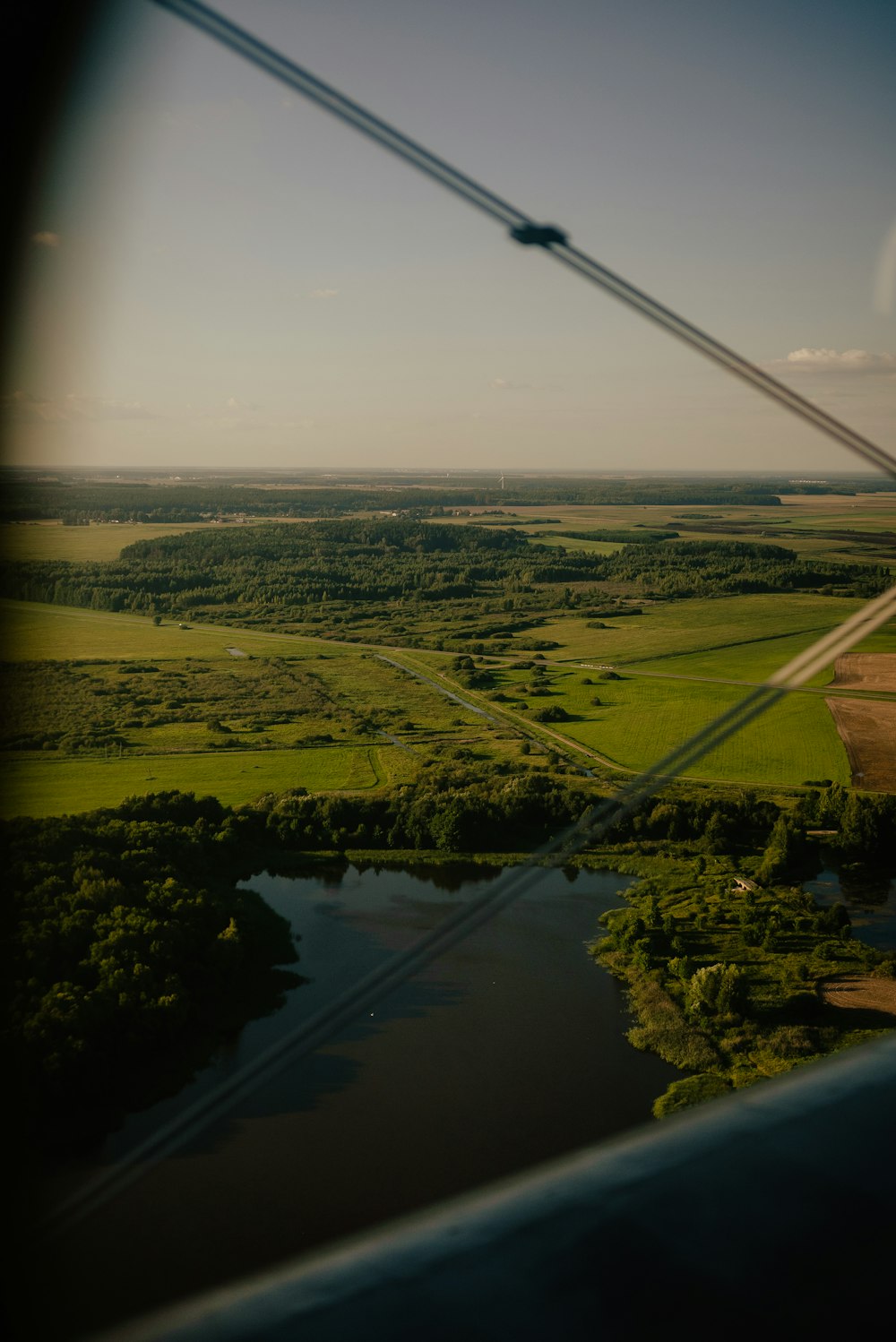 an aerial view of a river and a field