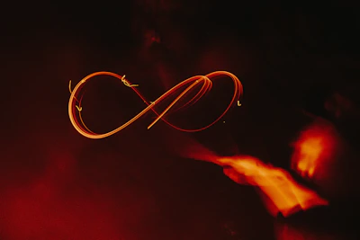 A glowing trifold flame symbol radiating ethereal light against a dark cosmic backdrop.