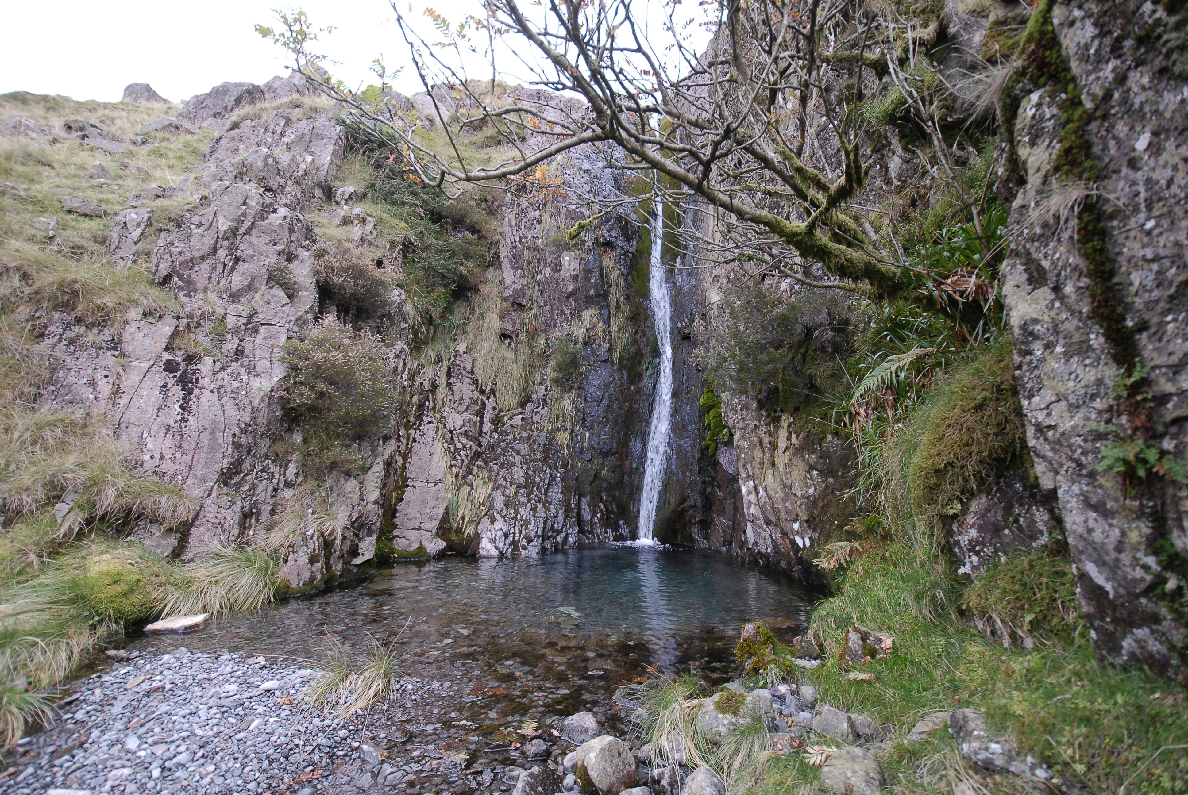 a small waterfall in the middle of a rocky area