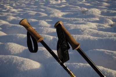 two ski poles sticking out of the snow