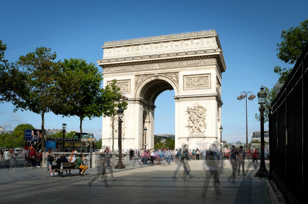 a group of people standing in front of a white arch